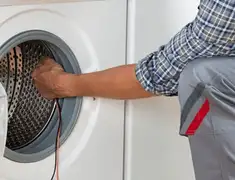 Dryer repair technician diagnosing and servicing a clothes dryer in Columbia, MO