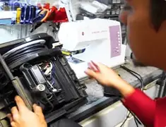 Vacuum repair technician servicing internal components on a workbench in Columbia, MO