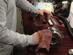 Vacuum repair technician cleaning and servicing a vacuum motor in Columbia, MO